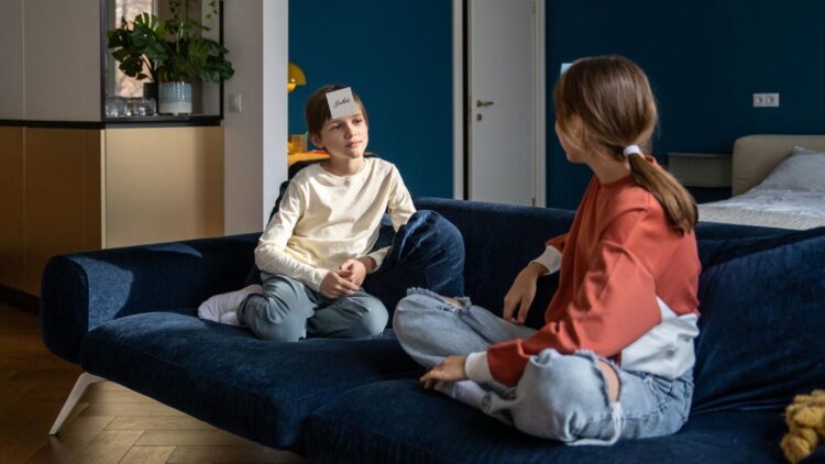 two kids playing who am i the bible edition